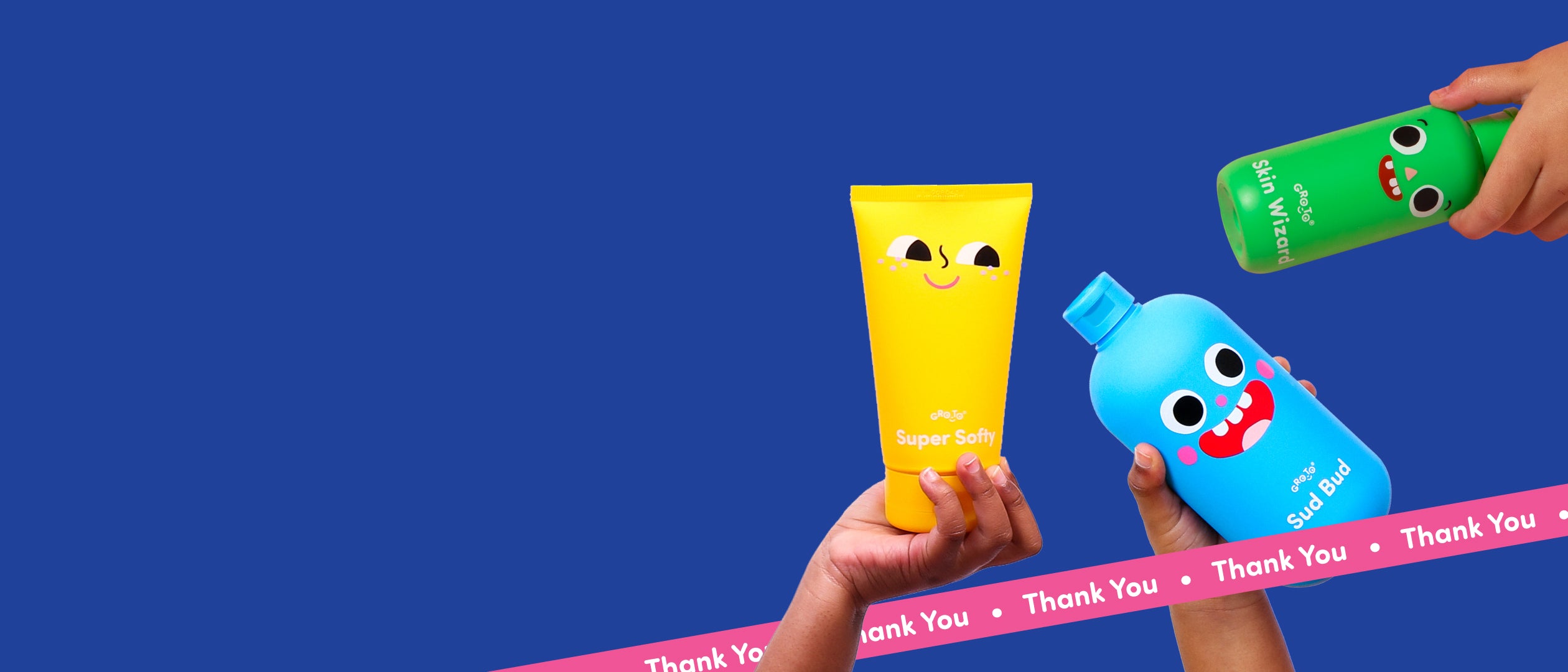 Three hands hold colorful, cartoon-faced bottles and tubes against a blue background; a yellow tube, a blue bottle, and a green bottle. A pink ribbon with Thank You repeats along the bottom.